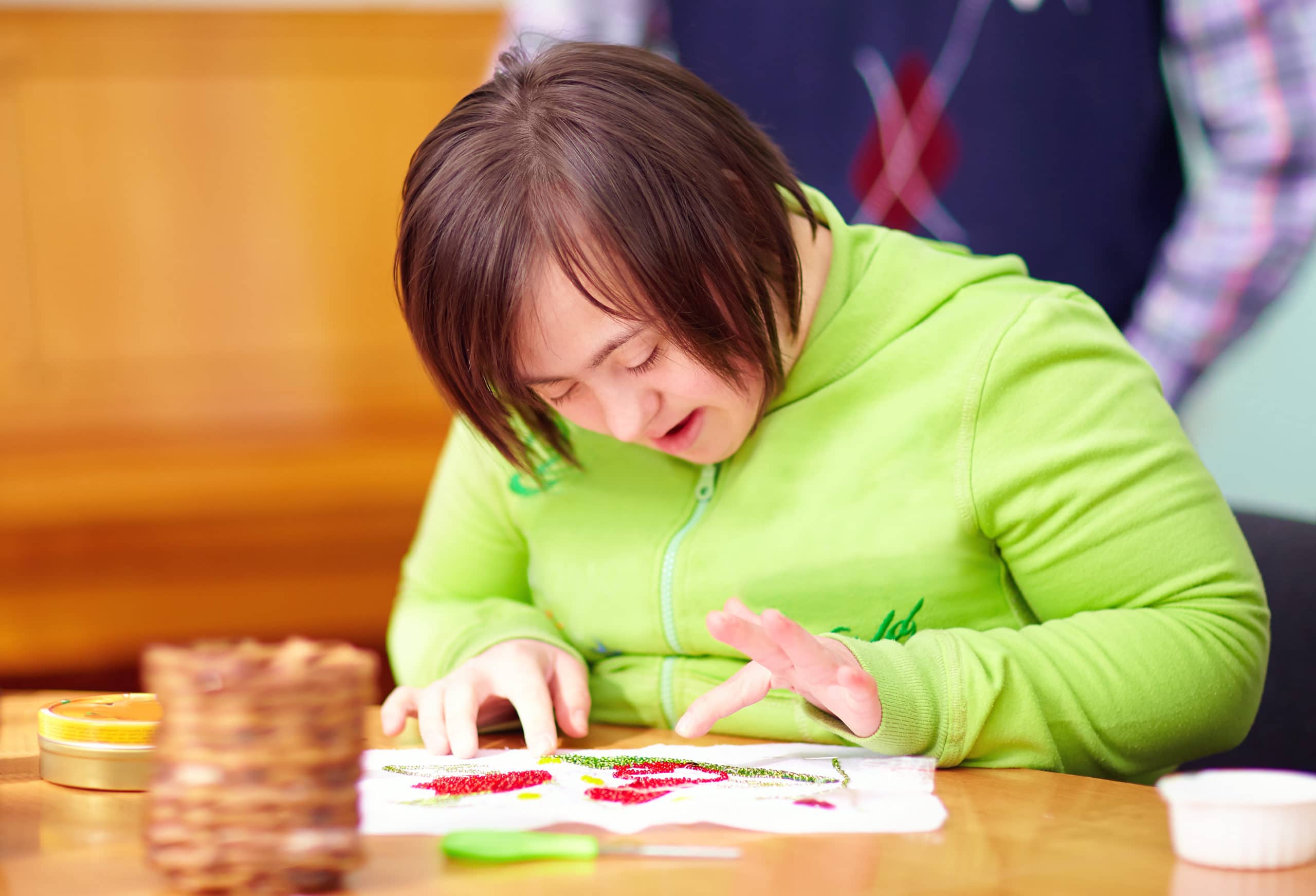 Young Adult Woman With Disability Engaged In Craftsmanship In Rehabilitation Center